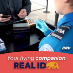 T S A agent checking traveler's REAL I D at airport security above text "Your flying companion REAL I D"