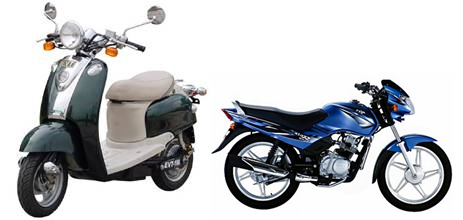 A green motor-driven cycle standing beside a blue motor-driven cycle